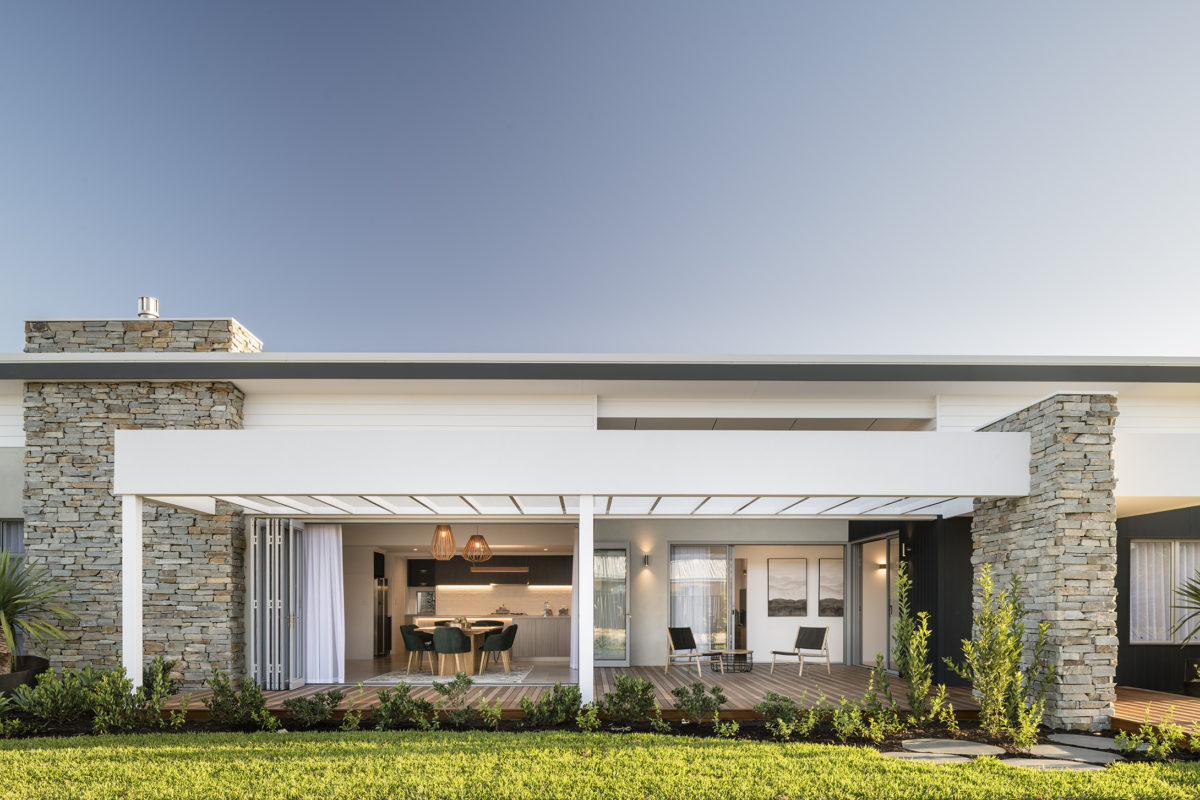 Contemporary home with open-plan alfresco and stone accents, ideal for corner block house designs with functional indoor-outdoor flow.