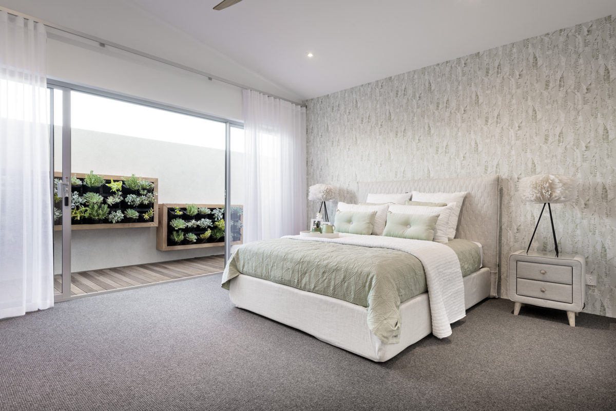 Serene master bedroom in the Bodega Bay design with outdoor courtyard access, ideal for private corner block house designs.