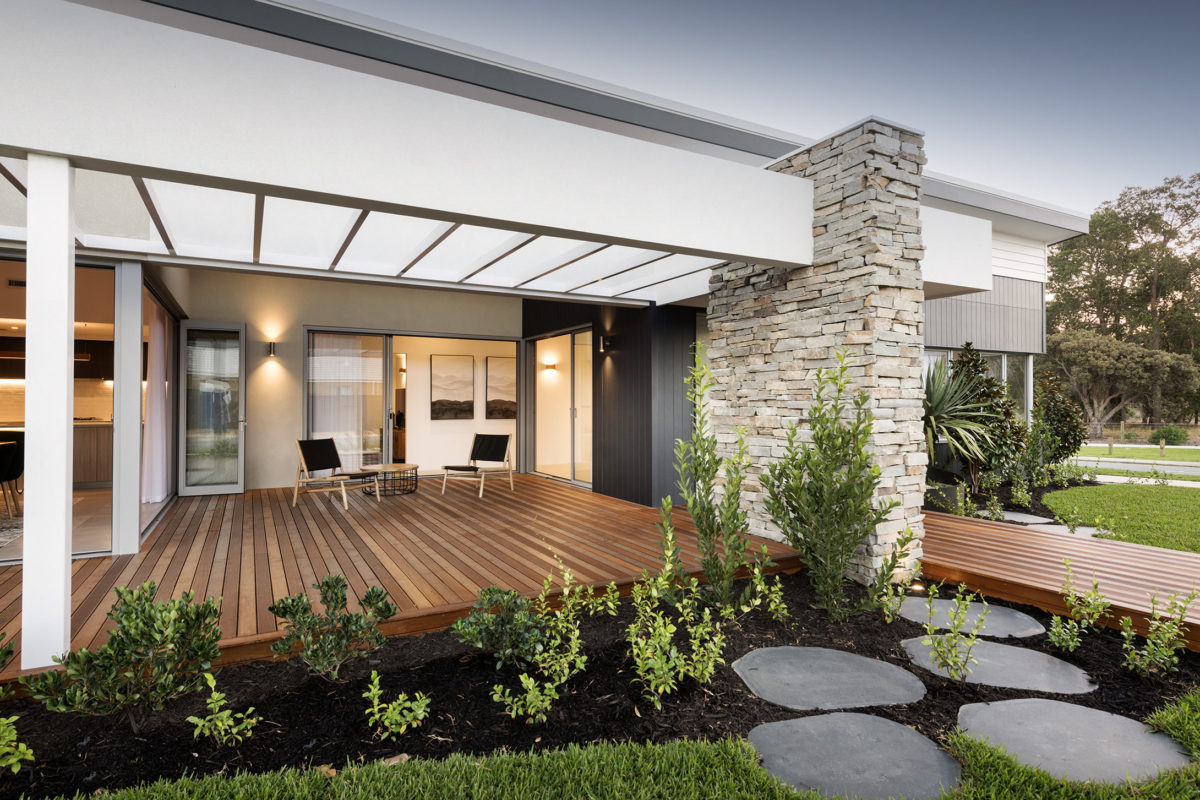 Timber-decked alfresco with stone feature wall and garden path, ideal for modern corner house designs and house plans on corner blocks.