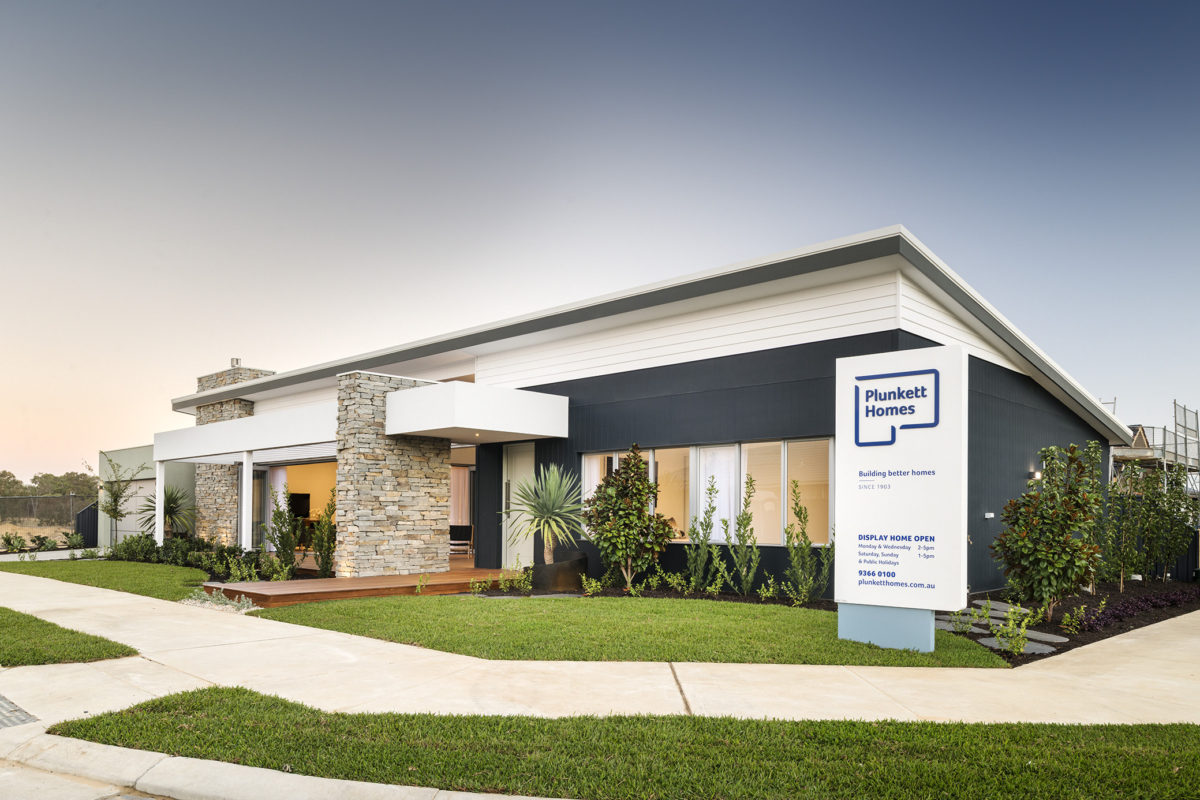 Modern display home by Plunkett Homes with striking stone façade, designed to suit corner block house designs and angled house plans.