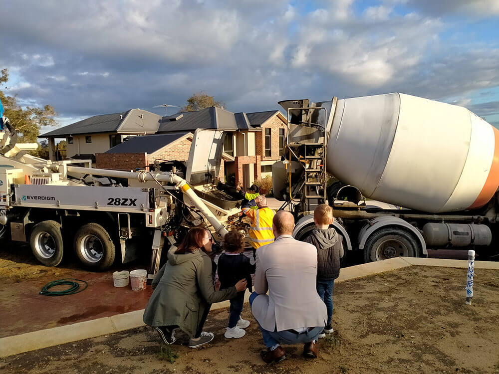 The Nederpelt family is looking at the concrete truck as they pour concrete slab for their new built home in Perth, WA