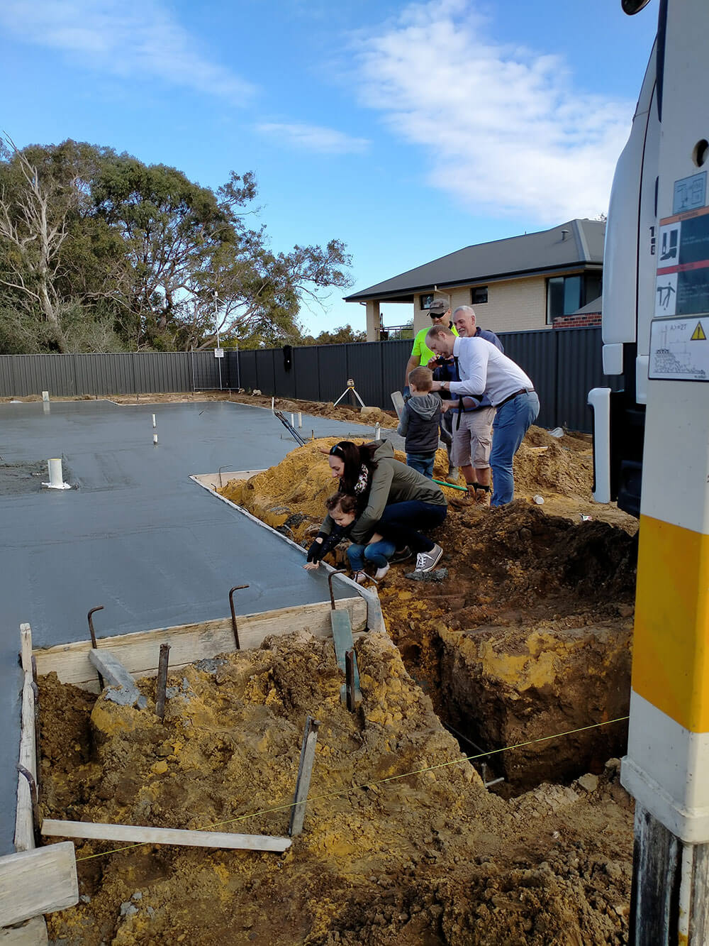 The Nederpelt family hand prints in the fresh concrete slab for their new built home in Perth